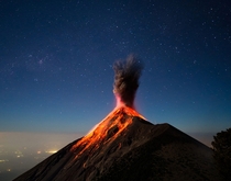 At around  am we awoke to the sound of a breath-stealing explosion I scrambled to the camera just in time to capture a moonlit and lava-covered Fuego as it put on this beautiful display of activity and power - Volcn de Fuego Guatemala  Photo by Andrew She