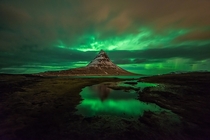 Aurora among the clouds before the arrival of a snowstorm on the Kirkjufell 