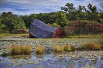 Barn falling off into a swamp Photo by Peter Stratmoen 
