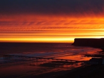 Beautiful amber skies complementing huntcliff Saltburn by the sea UK