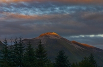Ben Nevis from Fort William - Suns rays just catching the top of the mountain Taken by my daughter Caitie Sankey  x 