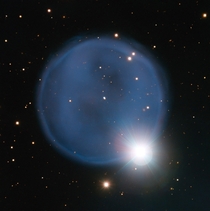 Better put a ring on it Abell  Created when an aging star blew off its outer layers this beautiful blue bubble is aligned with a foreground star and bears an uncanny resemblance to a diamond engagement ring This cosmic gem is unusually symmetric appearing