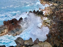 Blue waters of Hawaii crashing over the rocks at the Mackenzie State Recreation Area on the Big Island 