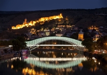 Bridge of Peace a bow-shaped pedestrian bridge a steal and glass construction illuminated with numerous LEDs over the Kura River in downtown Tbilisi capital of Georgia 