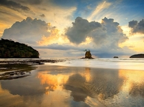 Building clouds and a setting sun reflect on a sandy beach on Costa Ricas Nicoya Peninsula Patrick di Fruscia 