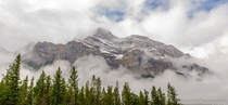 Canadian Rockies Rise Through the Clouds Above Banff 