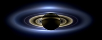 Cassini spacecraft slipped into Saturns shadow and turned to image the planet seven of its moons its inner rings -- and in the background our home planet Earth 