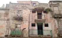 Cat jumping from one balcony to another between two abandoned buildings
