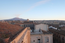 Catania Sicily Italy at Daybreak with Mt Etna smoking in the distance 