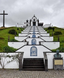 Church and steps made from volcanic lava rock and white plaster with azulejo tile murals in Sao Miguel Azores