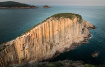 Cliff made out of hexagonal volcanic rock columns Po Pin Chau Hong Kong 