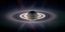 Composite photo of the Sun incandescing from behind Saturn That little dot in the top left area of Saturns rings is Earth 