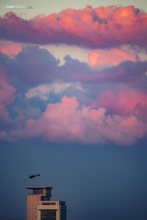 Cotton candy sky with a helicopter taking off 