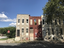 Crumbling abandoned rowhouses next to occupied ones in Baltimore Maryland 