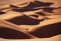 Curves - smooth sand dunes of the Sahara desert in Libya  photo by Ivan losar