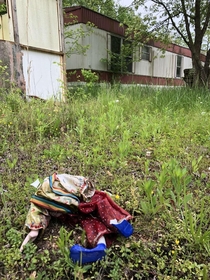 decapitated clown doll from this abandoned trailer in the boonies inside looked like it could have been nice in a past life but is now completely trashed and rotting reason for abandonment unknown