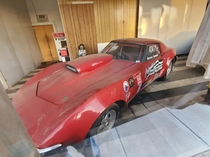 Drag vette inside abandoned machine shop Trans Am street racer next to this with  inspection sticker Note supercharged engine against the wall Lubbock Texas