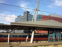 Dutch railway station Utrecht Overvecht with a train passing by 