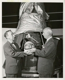 Earl Dorfman managing director of the National Historical Wax Museum presenting a model of astronaut Alan Shepards head to Philip Hopkins the director of the National Air Museum Washington DC September  