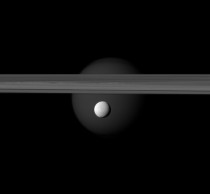 Enceladusw with Saturns rings and Titan in the background 