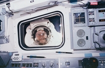 Even in space there are creepers Mission specialist Rick Hieb peers into the flight deck  