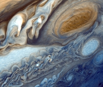 False-color detail of Jupiters atmosphere imaged by Voyager  showing the Great Red Spot and a passing white oval 