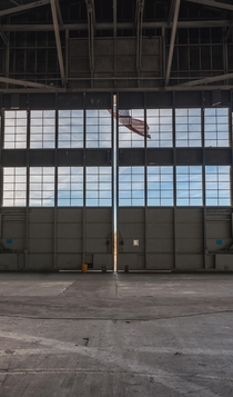 Flag hanging from an abandoned naval airbase hangar