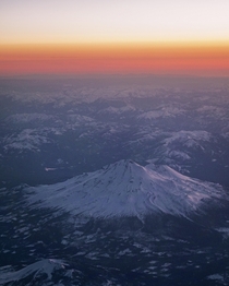 Flew over Northern California yesterday and took this picture of what I believe is Mount Shasta during sunset 