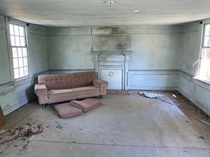 Forgotten couch in a long-abandoned farm house in rural North Carolina