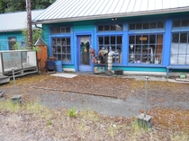 Found on Route  in Oregon I think it was a single pump gas station at one time and was turned into an antique shop before being abandoned More pics in comments Thats a carpet on the ground with moss covering it