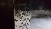 found this room in an abandoned milk factory in greece the word sorry is written all over the walls