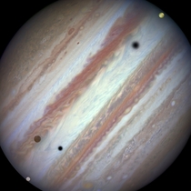 Galilean moons Europa Callisto and Io pass in front of Jupiter Photo of this rare triple-moon conjunction taken by the Hubble Space Telescope 