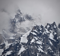 Glacier covered peaks emerge from the clouds in the Alaska Range 