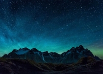 Green Airglow appearing in the night sky behind the mountains of Vestrahorn Iceland 