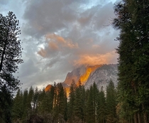 Half Dome Yosemite covered by clouds The sun shining through caused this on fire illusion 