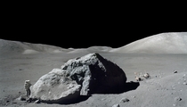 Harrison H Schmitt photographed standing next to a huge split lunar boulder during the third Apollo  extravehicular activity EVA at the Taurus-Littrow landing site 