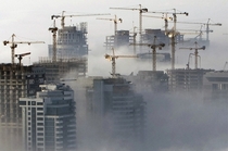 Heavy fog rolls by high-rise constructions near the Dubai Marina 