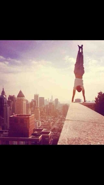 Hey reddit thought you all would find this coolinterestinginsaneridiculous A friend of mine did a handstand on a ledge of the th floor of his building yesterday with the beautiful New York skyline as a backdrop 