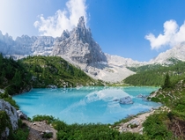 Hiked over a mountain pass to a blue lake under blue skies in Italy Lago di Sorapis 