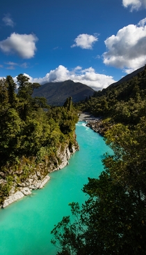 Hokitika Gorge in the west coast of the south island of New Zealand The bright cyber cyan color of the water is due to the suspended minerals and limestone being ground in to the water from the glaciers upstream from this river The alps average m of rainf