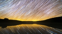 I photographed the Earths motion relative to the stars in front of a perfectly still lake