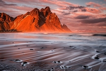 I used a two-second exposure to capture the water trails as the waves receded over rocks just as the sun was setting behind me illuminating the mighty Vestrahorn mountain and some peaks in the far distance  Photo by Sophie Carr