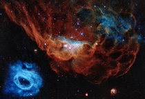 Image celebrating Hubbles th birthday the giant red nebula NGC  and its smaller blue neighbor NGC  are part of a vast star-forming region in the Large Magellanic Cloud