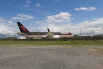 In a remote corner of a quiet airport sits a trophy plane waiting for parts or better times 