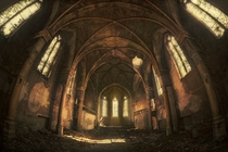 Inside the debris-strewn hall of an abandoned church  By DARKstyle Pictures