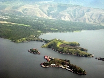 Islands ringed with houses Lake in West Papua Indonesia 