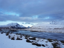 It snowed on our road trip last month and the loch was completely frozen over - Knockan Crag National Nature Reserve Scotland