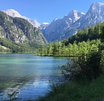 Lake Almsee in front of the Totes Gebirge literally dead mountain range due to a lack of vegetation on top of the karst formation Upper Austria end of July  