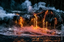 Lava from the Kilauea volcano flowing into the ocean Taken in Hawaii by Alexandre Socci xpost rLavaPorn 
