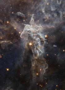 Less colorful but equally stunning view of one of the pillars of creation deep inside Messier  Eagle Nebula  light-years from earth This pillar is roughly  light-years tall Hubble